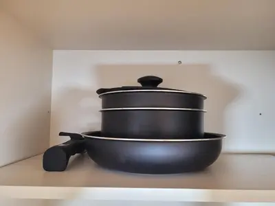 a black pot sitting on top of a stove at Liberty Shinjuku House in Tokyo
