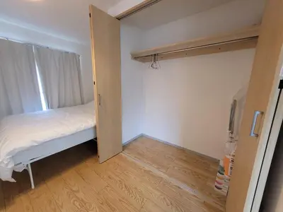 a small bedroom with a bed and a closet at Liberty Shinjuku House in Tokyo