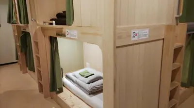 a couple of bunk beds in a room at \u65e5\u672c\u30ef\u30a4\u30f3\u30d0\u30c3\u30af\u30d1\u30c3\u30ab\u30fc\u30ba in Tokyo