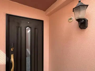 a hallway with a door and a lamp on a wall at EV-Akabane House-KI0414 in Tokyo