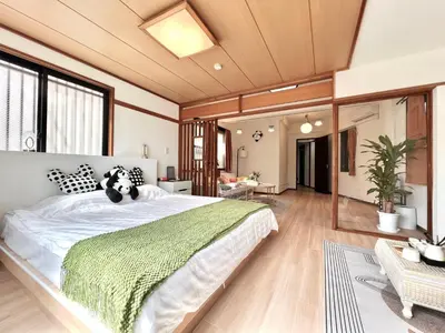 a bedroom with a large bed with a dog on it at EV-Akabane House-KI0414 in Tokyo