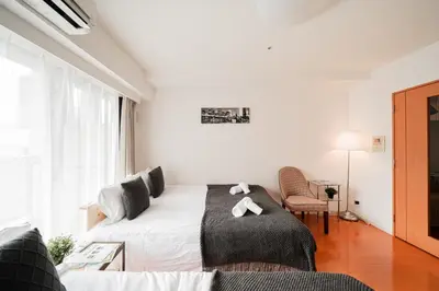 a white room with a bed and a couch at Shinjuku luxury Apart ment 2 minutes from Higashi-Shinjuku in Tokyo