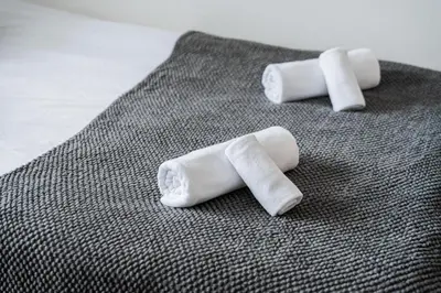 three rolled up white marshmallows sitting on a table at Shinjuku luxury Apart ment 2 minutes from Higashi-Shinjuku in Tokyo