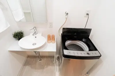 a bathroom with a washing machine and a sink at Shinjuku luxury Apart ment 2 minutes from Higashi-Shinjuku in Tokyo