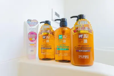a group of four orange bottles sitting on a shelf at Shinjuku luxury Apart ment 2 minutes from Higashi-Shinjuku in Tokyo