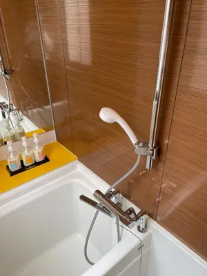 a bathroom with a bath tub with a faucet at Business Hotel Crescent - Vacation STAY 49950v in Tokyo