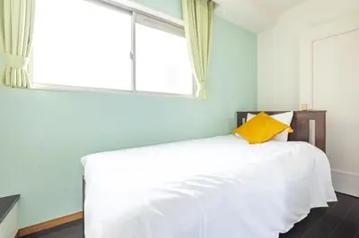a bedroom with a white bed with a window at ISI Building, 6th Floor - Vacation STAY 27331v in Tokyo