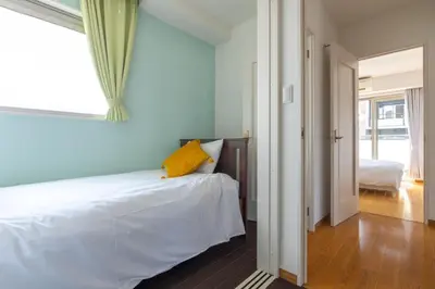 a bedroom with a bed with a yellow pillow on it at ISI Building, 6th Floor - Vacation STAY 27331v in Tokyo