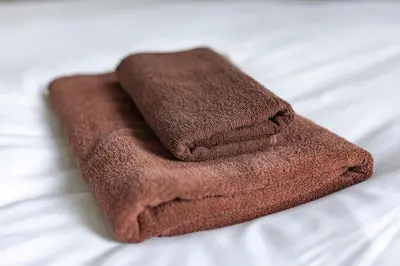 a pile of brown towels sitting on a bed at ISI Building, 6th Floor - Vacation STAY 27331v in Tokyo