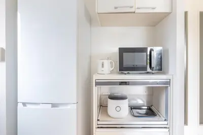 a small kitchen with a microwave and a tv at ISI Building, 6th Floor - Vacation STAY 27331v in Tokyo