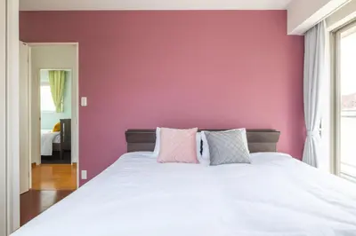 a bedroom with a white bed with a pink wall at ISI Building, 6th Floor - Vacation STAY 27331v in Tokyo
