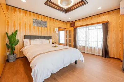 a bedroom with a large bed and a window at ZSF-Kameido House -KT0413 in Tokyo