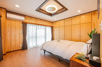 a bedroom with a large bed and a window at ZSF-Kameido House -KT0413 in Tokyo