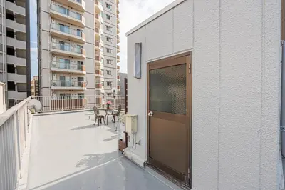 a balcony with a door on the side of a building at ZSF-Kameido House -KT0413 in Tokyo