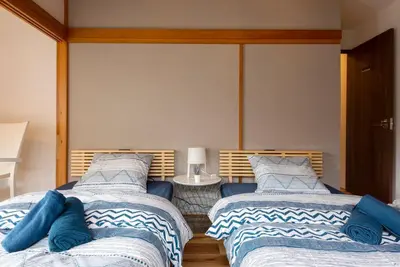 two beds sitting next to each other in a bedroom at \u4e00\u68df\u8cb8\u3057\u5e83\u3005115\u5e73\u7c73 \u8cb4\u9802\u5e9c\u90b8 \u5927\u8c37\u7530 KICYO HOUSE No1 in Tokyo