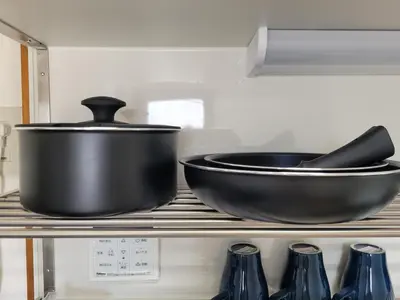 two pans sitting on a shelf in a kitchen at Ema eve HOUSE in Tokyo