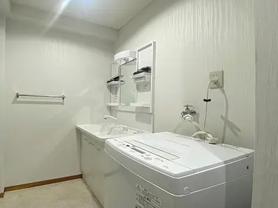 a white bathroom with a sink and a mirror at Ema eve HOUSE in Tokyo