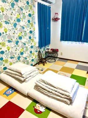a room with a bed with towels on the floor at Sakura Bloom Separate House in Tokyo