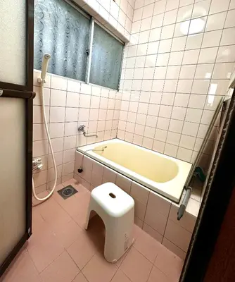 a bathroom with a tub and a toilet in it at Sakura Bloom Separate House in Tokyo
