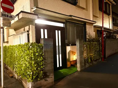 a front door of a building with green plants at Sakura Bloom Separate House in Tokyo
