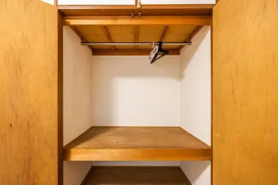 a closet with wooden shelves in a room at residencematsubara in Tokyo