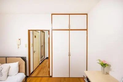 a bedroom with sliding glass doors and a bed at residencematsubara in Tokyo