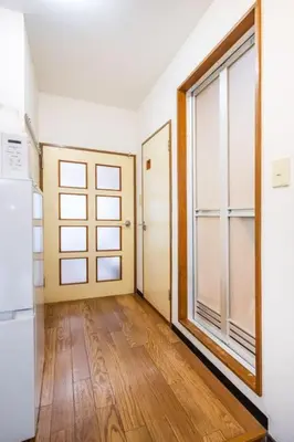 an empty room with a door and a window at residencematsubara in Tokyo
