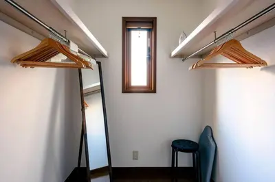 a room with three wooden hangers on the wall at Haresora Mukojima Ikken House in Tokyo