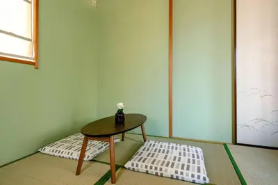 a table with a vase on it in a room at Haresora Mukojima Ikken House in Tokyo