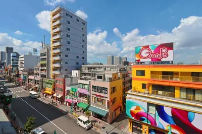 a city with tall buildings and a street with cars at V Close to Shinjuku Kabukicho Korean Town FrWIFI F in Tokyo