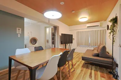 a dining room with a table and chairs and a couch at V Close to Shinjuku Kabukicho Korean Town FrWIFI F in Tokyo