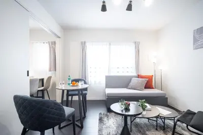a living room with a couch and a table at \u30a6\u30a7\u30eb\u30b9\u30af\u30a8\u30a2\u30a4\u30ba\u30e0\u6c60\u888b\u30a6\u30a7\u30b9\u30c8 in Tokyo