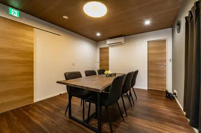 a dining room with a wooden table and chairs at 99, Higashi-tateishi A 2nd and 3rd floor apartment, \u6771\u7acb\u77f3A 2F,3F in Tokyo