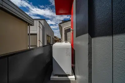 a washing machine sitting on the side of a building at 99, Higashi-tateishi A 2nd and 3rd floor apartment, \u6771\u7acb\u77f3A 2F,3F in Tokyo