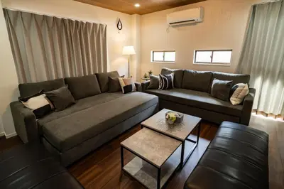 a living room with a couch and a table at 99, Higashi-tateishi A 2nd and 3rd floor apartment, \u6771\u7acb\u77f3A 2F,3F in Tokyo