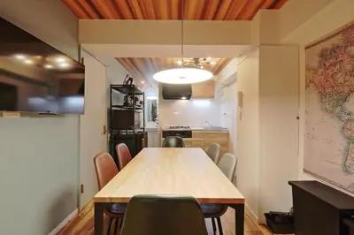 a dining room with a wooden table and chairs at V Close to Shinjuku Kabukicho Korean Town FrWIFI G in Tokyo