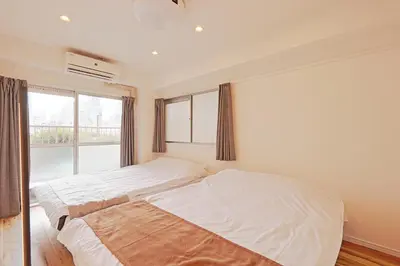a bedroom with two beds and a window at V Close to Shinjuku Kabukicho Korean Town FrWIFI G in Tokyo