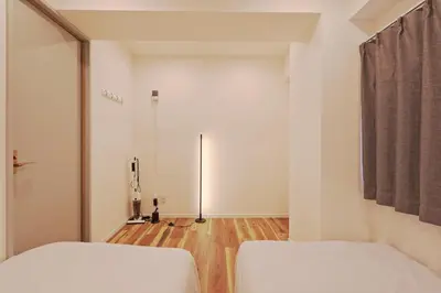 a bedroom with two white beds and a hallway at V Close to Shinjuku Kabukicho Korean Town FrWIFI G in Tokyo
