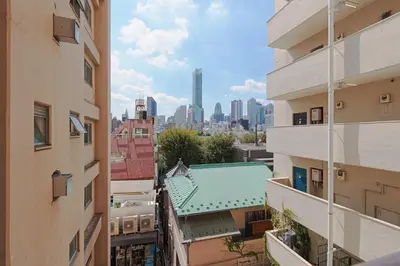 a view of the city from between buildings at V Close to Shinjuku Kabukicho Korean Town FrWIFI G in Tokyo