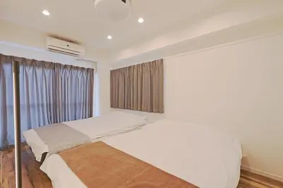 a bedroom with two beds and a window at V Close to Shinjuku Kabukicho Korean Town FrWIFI G in Tokyo