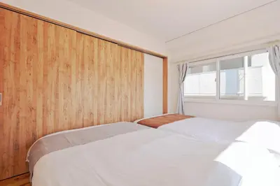 two beds in a bedroom with a window at V Close to Shinjuku Kabukicho Korean Town FrWIFI H in Tokyo