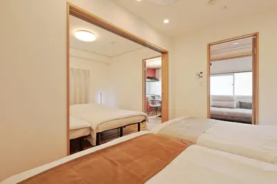 a bedroom with two beds and a large mirror at V Close to Shinjuku Kabukicho Korean Town FrWIFI H in Tokyo
