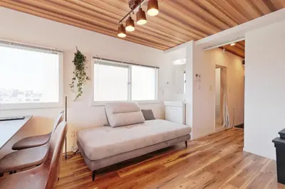 a living room with a couch and two windows at V Close to Shinjuku Kabukicho Korean Town FrWIFI H in Tokyo