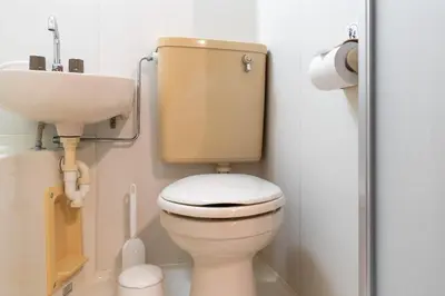 a bathroom with a toilet and a sink at \u30b0\u30ed\u30fc\u30d9\u30eb \u30b6 \u30af\u30ec\u30b9\u84b2\u7530 in Tokyo