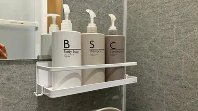 a bathroom shelf with four white bottles on it at Tokyo villa Ryogoku in Tokyo