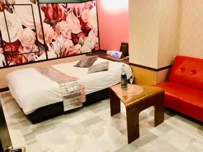 a bedroom with a bed and a red chair at \u30db\u30c6\u30eb\u30b7\u30a7\u30cc\u30fcAdult Only in Tokyo