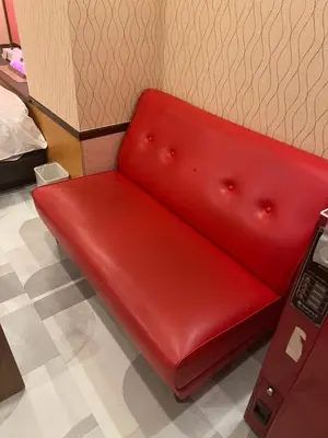 a red couch sitting in a room at \u30db\u30c6\u30eb\u30b7\u30a7\u30cc\u30fcAdult Only in Tokyo