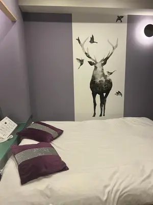a bedroom with a bed with a deer on the wall at \u30db\u30c6\u30eb\u30b7\u30a7\u30cc\u30fcAdult Only in Tokyo