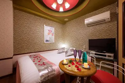 a hotel room with a bed and a table with candles at \u30db\u30c6\u30eb\u30b7\u30a7\u30cc\u30fcAdult Only in Tokyo