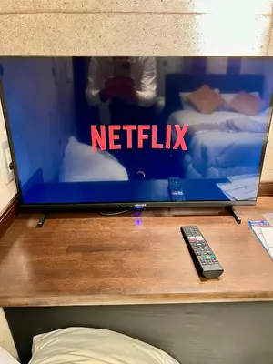 a tv sitting on a table with a remote control at CoreHOTEL in Tokyo
